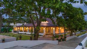 a house with a lot of windows and a tree at Sirinary Villa - Natai Phangnga in Ban Na Tai