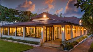 a house with a lot of windows at Sirinary Villa - Natai Phangnga in Ban Na Tai