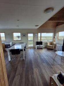 a large living room with a table and chairs at Mid-Sel mountain view lodge in Hella