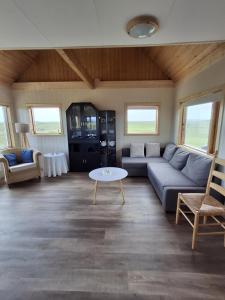 a living room with a couch and a table at Mid-Sel mountain view lodge in Hella