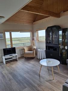 a living room with a couch and a table at Mid-Sel mountain view lodge in Hella