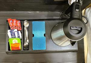 a metal tray with utensils on top at Hotel Pearl Nest Palace in Agra