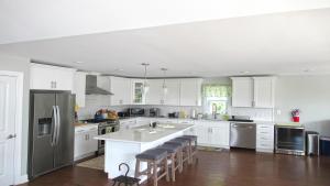 a kitchen with white cabinets and stainless steel appliances at Bay Breeze in Town Bank