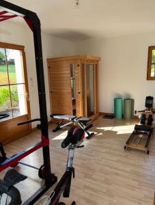 a gym with several exercise bikes in a room at Iroise in Combrit