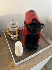 a red coffee maker on a tray in a refrigerator at Mamy Sweet Loft in Polignano a Mare +13 photos