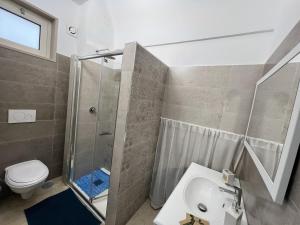 a bathroom with a shower and a toilet and a sink at Mamy Sweet Loft in Polignano a Mare