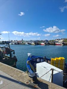 a boat is docked at a dock in the water at Studio Les 4 Vents in Tréffiagat +6 photos