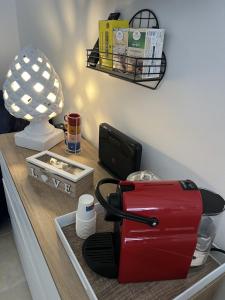 a red toaster sitting on top of a counter at Mamy Sweet Loft in Polignano a Mare
