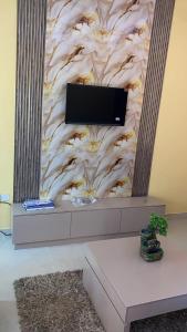a wall with a tv on top of it at The Oasis in Oko Erin