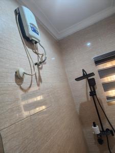 a shower in a bathroom with a camera on the wall at The Oasis in Oko Erin