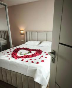 a large bed with a flower arrangement on it at Žolynų namai in Klaipėda +17 photos