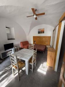 a living room with a table and a couch at Tornac, La Madeleine in Tornac