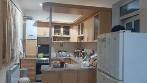 a kitchen with a white refrigerator and a stove at Sanahin in Alaverdi
