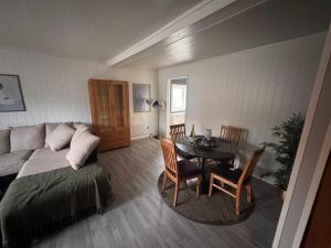 a living room with a bed and a table and a table at 2 beds apartment centrally located in Gravdal in Gravdal
