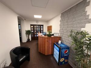 an office with a desk and a chair in a room at Hotel Zlatý Kříž in Teplice