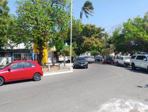 a red car parked on the side of a street at Rinconcito Veracruzano in Veracruz