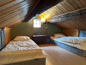 a bedroom with two beds in a attic at Stuga med havsutsikt in Strömstad