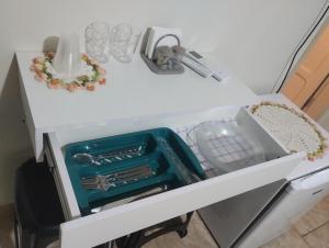 a white table with a drawer filled with dishes at Edícula 1 em São Pedro in São Pedro