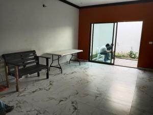 a man sitting in a room with a table and a bench at Residencia de Lujo in Tapachula +18 photos