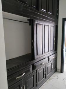 a dresser in a living room with black cabinets at Residencia de Lujo in Tapachula