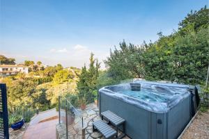 a hot tub sitting on top of a patio at CASA CHAGUIMAMA Begur in Begur