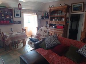 a living room with a couch and a table at Historic old Cottage Co Mayo in Ballinrobe +34 photos