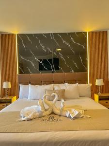 a bedroom with a bed with a stuffed animal on it at Hotel Anddari in Arequipa +82 photos