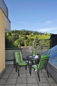 a patio with a table and chairs on a balcony at Appartement 4You in Schladming