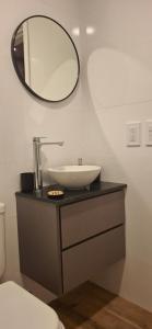 a bathroom with a sink and a mirror at Depto Zona Güemes Mdp in Mar del Plata +11 photos