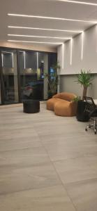 an empty room with a bed and a chair in it at Depto Zona Güemes Mdp in Mar del Plata