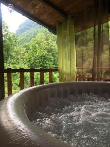 a hot tub in a house with a view of a mountain at Il Borgo Don Camillo in Pian di Novello