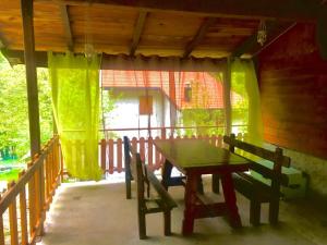 a table and bench on the porch of a house at Il Borgo Don Camillo in Pian di Novello +18 photos