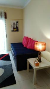 a bedroom with a bed and a table with a lamp at Luz de Cacilhas Apt, few steps away from Lisboa! in Almada