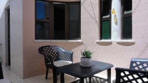 a table and chairs sitting on a patio at Luz de Cacilhas Apt, few steps away from Lisboa! in Almada