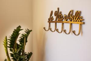 a group of hangers on a wall next to a plant at Le Rose Suites - Misano World Circuit & Beach in Misano Adriatico