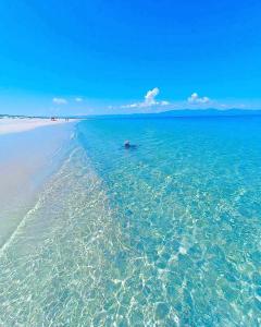 a person in a boat in the water on a beach at Salty Sun Cabins Bahía Turquesa in La Ventana