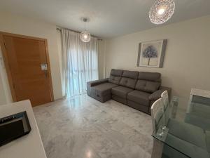 a living room with a couch and a window at Apartment Lucena Center Bajo Parking Gratis in Lucena