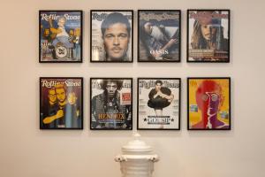 a group of framed movie posters on a wall at Le Rose Suites - Misano World Circuit & Beach in Misano Adriatico