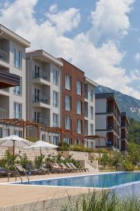 an image of a hotel with a swimming pool at Adriatic Heights Holiday Apartments in Kavač
