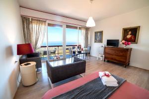 a bedroom with a living room with a view of the ocean at Belvedere del Lago in Montefiascone +40 photos