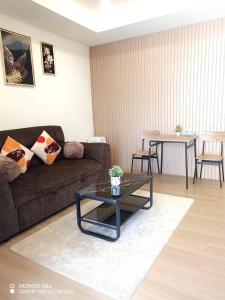a living room with a couch and a table at Peace Homestay Hat Yai in Hat Yai