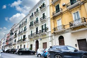 a row of cars parked in front of buildings at La Casa del Faro in Taranto