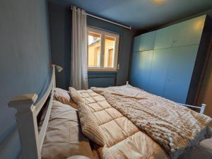 a bedroom with a bed and a window at Green Oasis Garda Apartment in Riva del Garda