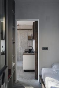 a kitchen with a sink and a bed in a room at Ukino House in Nikiana