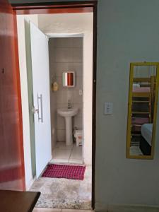 a small bathroom with a sink and a mirror at Pousada Seu Jorge in Campinas +40 photos