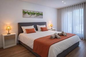 a bedroom with a large bed with two lamps at The Douro Nest in Valença do Douro +27 photos