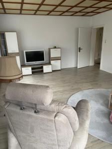 a living room with a couch and a tv at Ferienhaus in der Altmark in Kakerbeck