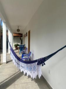 a hammock on the side of a house at Pousada Casa da Praticagem in Salinópolis