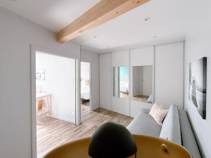 a living room with a couch and a mirror at L'Appart du Faubourg 1 à 8 Personnes in Valence