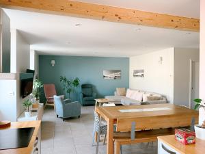 a living room with a couch and a table at L'Appart du Faubourg 1 à 8 Personnes in Valence